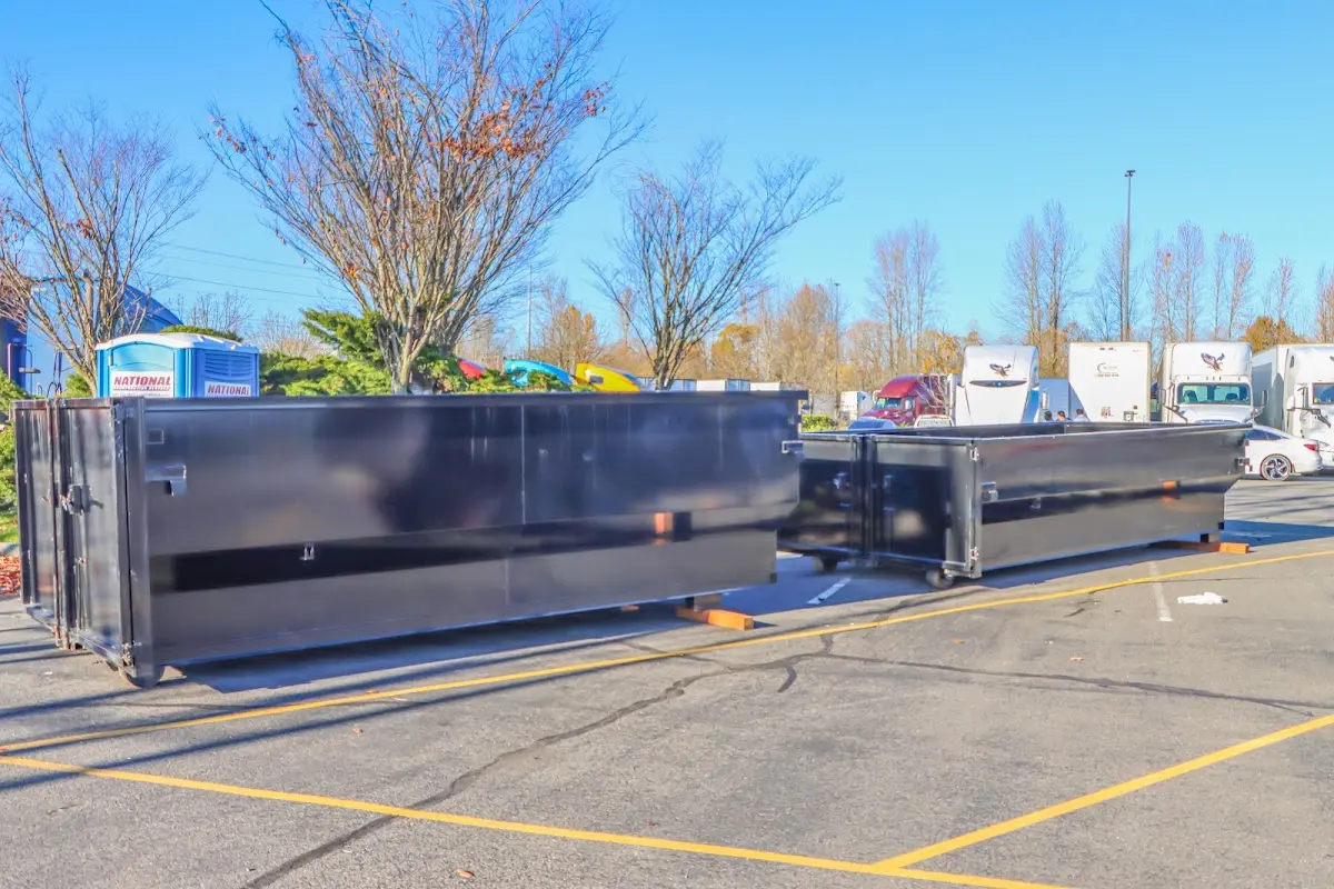 Professional dumpster rental service with roll-off container on residential driveway in Oskaloosa